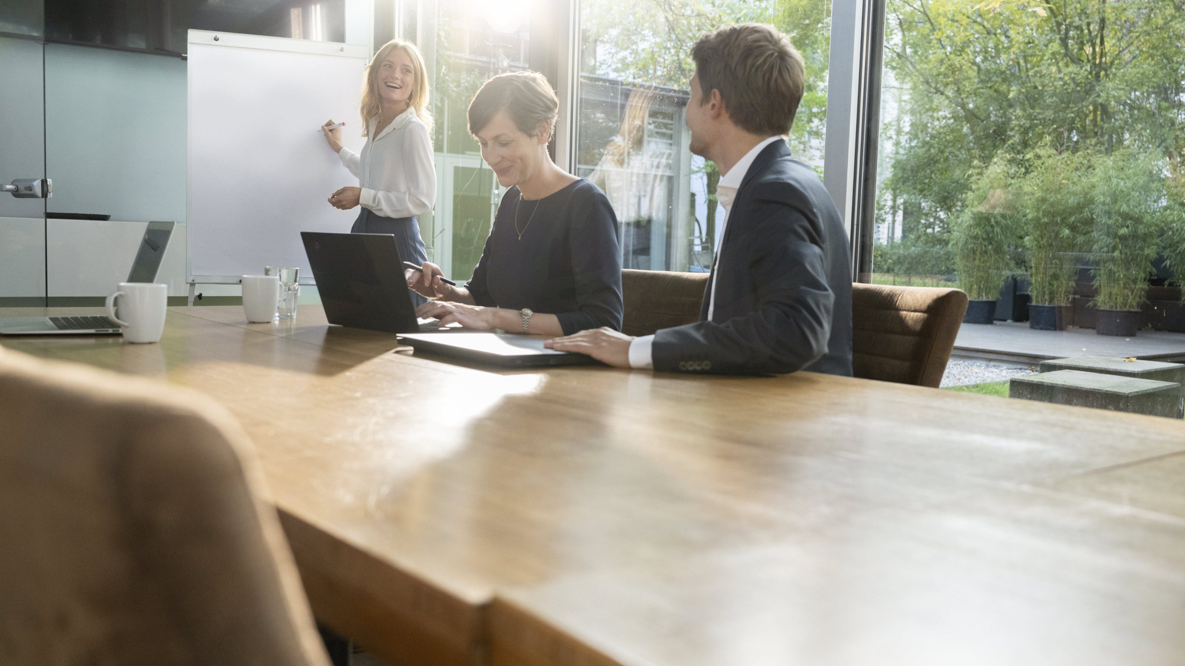 Three employees have a meeting in the office space, discussing the results of a study