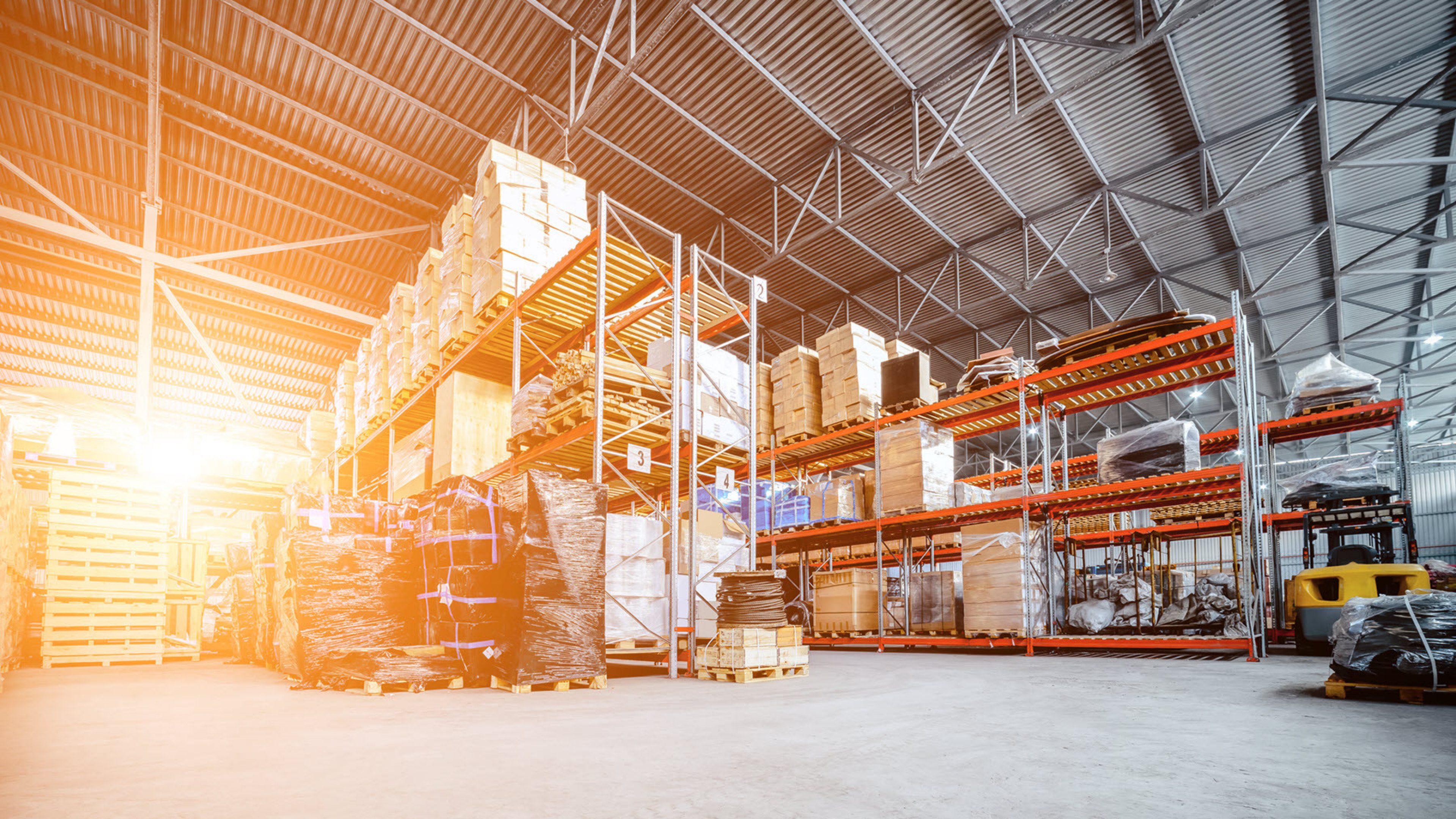 Storage hall with high shelves and forklift truck