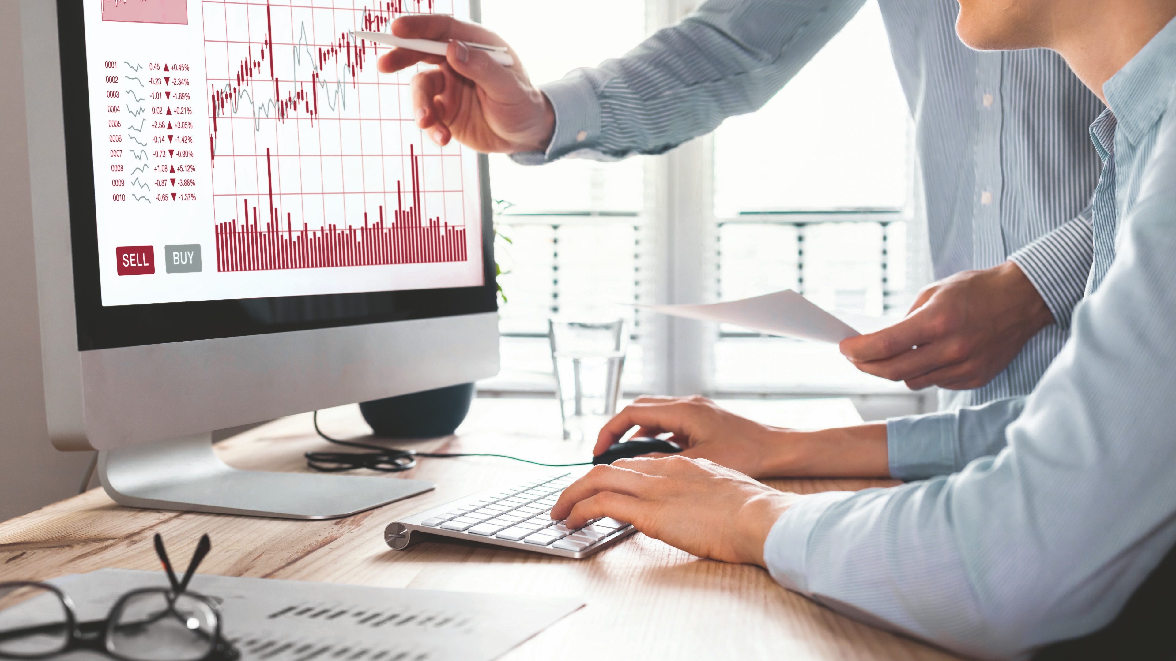 Team of traders working with forex (foreign exchange) trading charts and graphs on computer screen, concept about stock market investment, finance, selling and buying