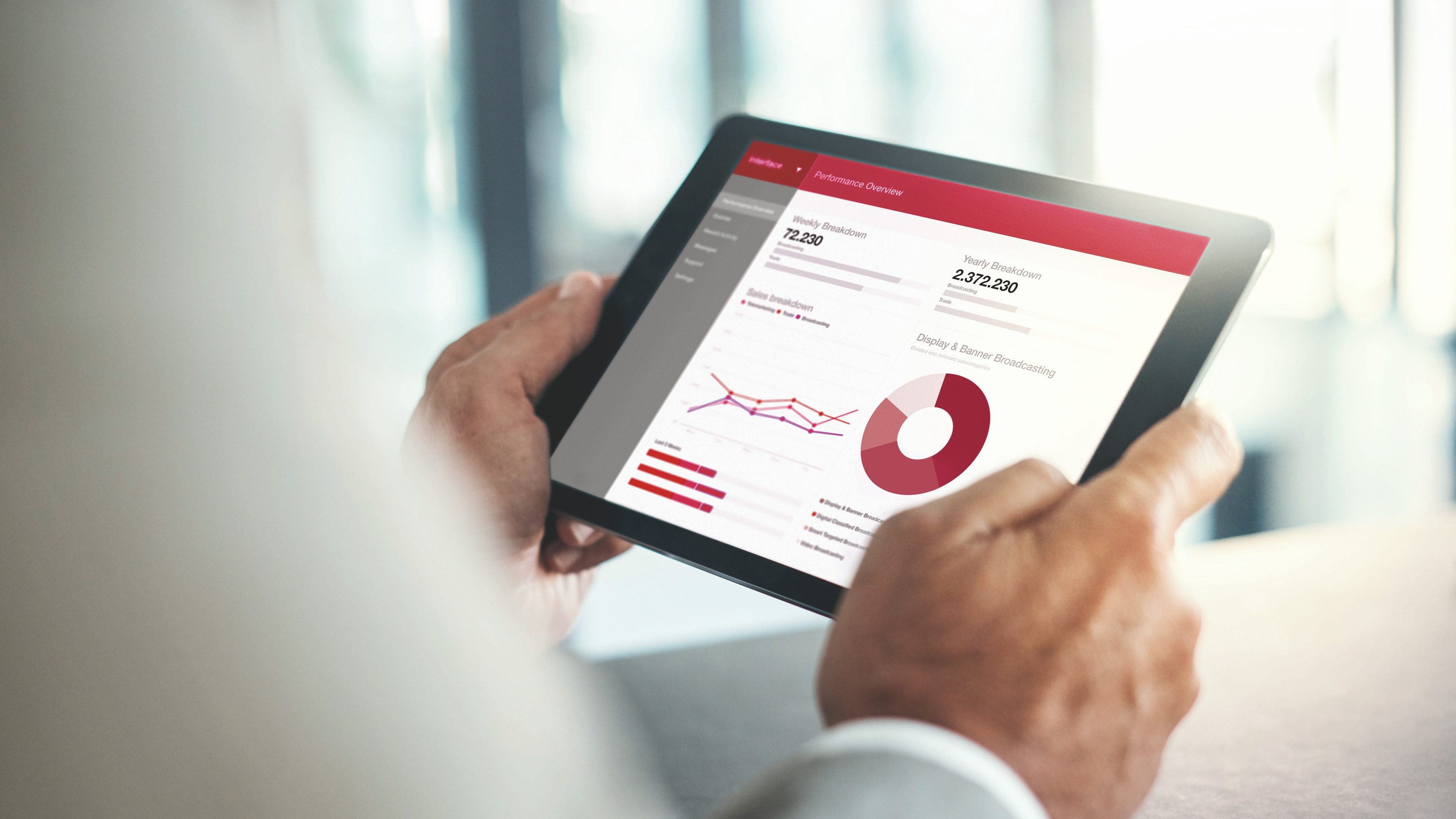 Cropped shot of a businessman using a digital tablet with graphs on the screen