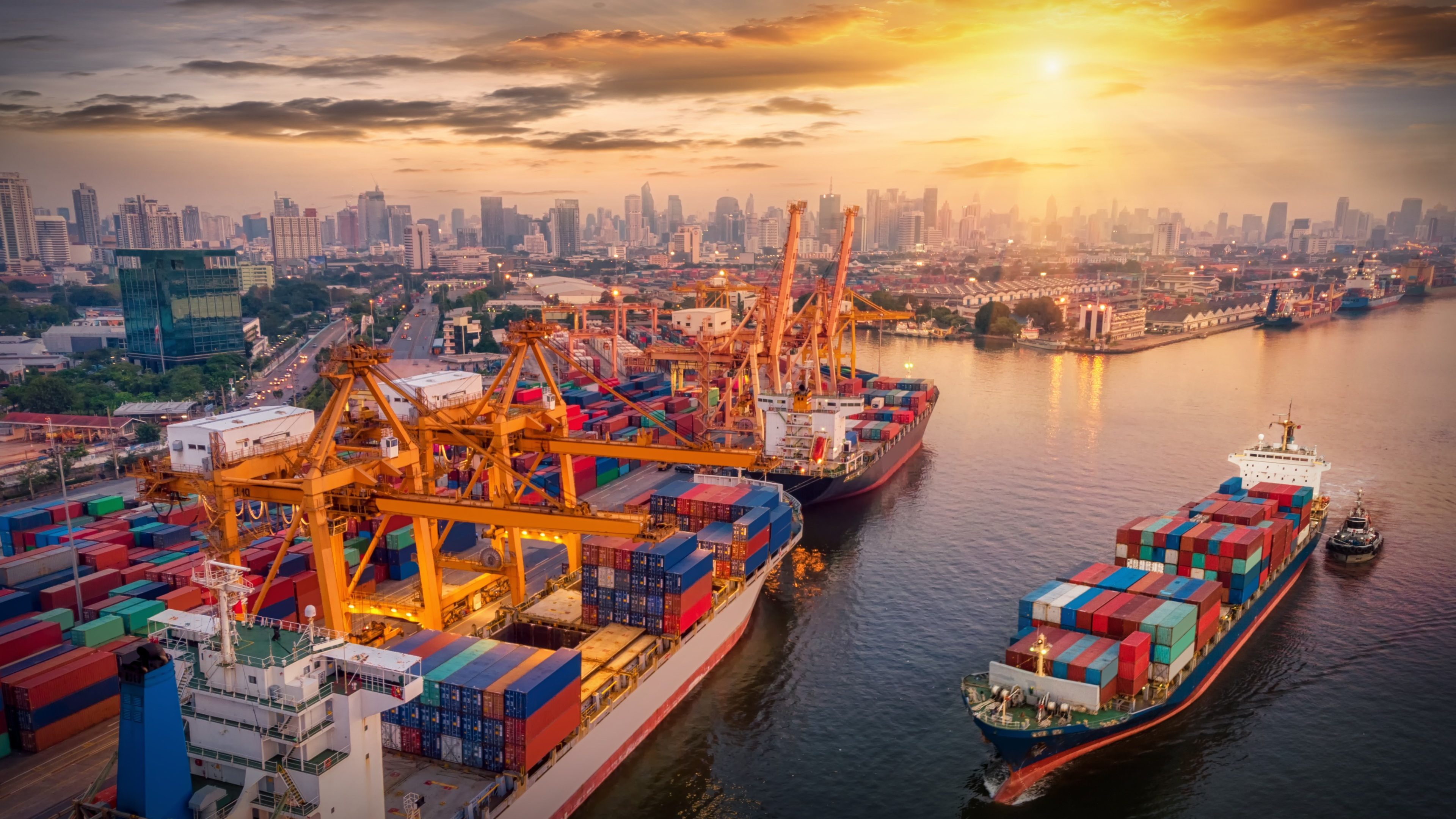 Logistics and transportation of Container Cargo ship and Cargo plane with working crane bridge in shipyard at sunrise, logistic import export and transport industry background