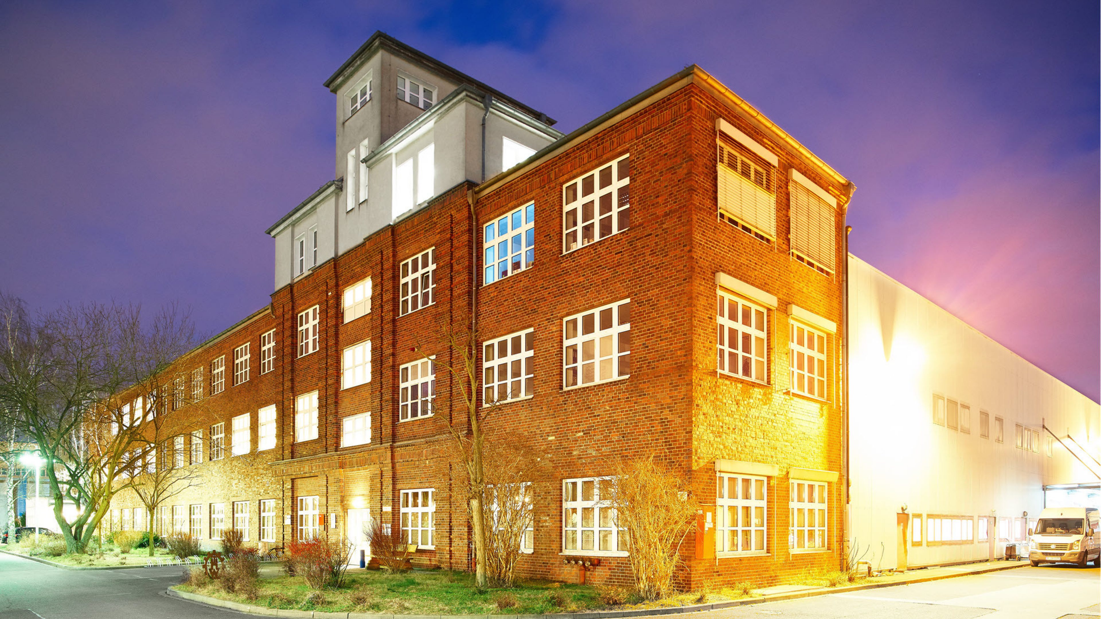 A brightly illuminated brick building with big windows