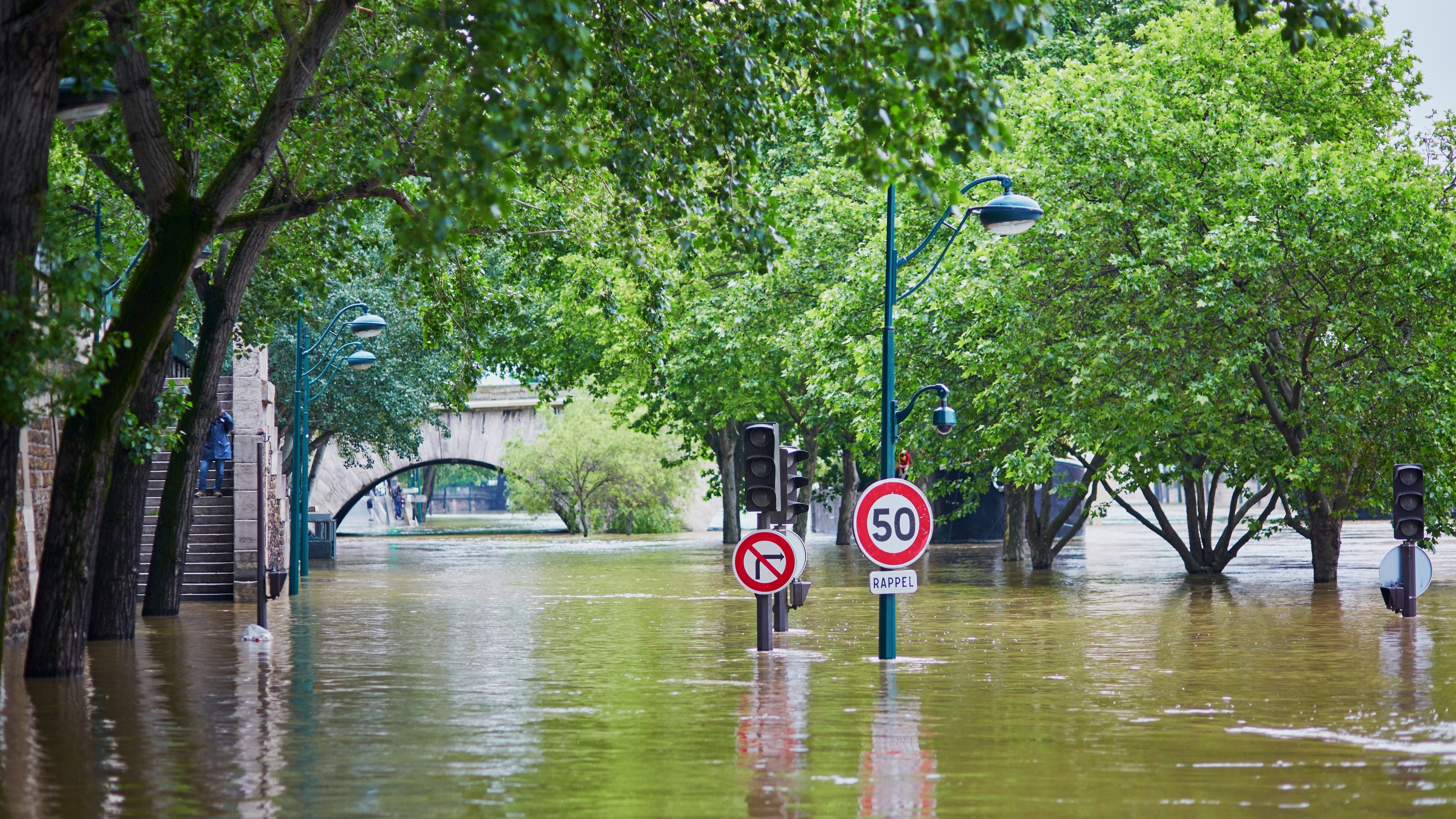 Flood in Paris, extremely high water on the river Seine, road signs covered with water